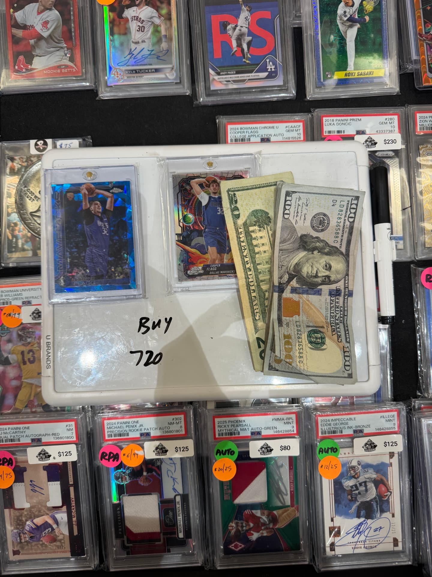 Sports cards with cash on a buy tray